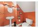 Charming powder room with a pedestal sink, round mirror and classic art decor at 2311 Club Rd, Charlotte, NC 28205