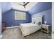 Cozy blue bedroom with a white bed, shutters, and a ceiling fan at 2311 Club Rd, Charlotte, NC 28205