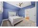 Bright bedroom with a ceiling fan, white bed, and views to the hallway and staircase at 2311 Club Rd, Charlotte, NC 28205