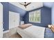 Comfortable bedroom featuring a ceiling fan, shuttered windows, and ample natural light at 2311 Club Rd, Charlotte, NC 28205