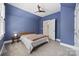 Charming bedroom with blue walls, ceiling fan, and access to the hallway at 2311 Club Rd, Charlotte, NC 28205