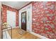 Inviting foyer with hardwood floors, colorful wallpaper, and a charming front door at 2311 Club Rd, Charlotte, NC 28205