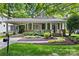 Charming home exterior featuring a covered porch, well-manicured landscaping, and a welcoming entrance at 2311 Club Rd, Charlotte, NC 28205