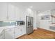 Modern kitchen with white cabinetry, stainless steel appliances, and tiled backsplash at 2311 Club Rd, Charlotte, NC 28205