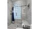 Contemporary shower with marble tile, glass enclosure, shower seat, and blue curtain accent at 2311 Club Rd, Charlotte, NC 28205