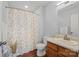 Cozy bathroom featuring a floral shower curtain and wood-look flooring at 233 E Waterlynn Rd # B, Mooresville, NC 28117