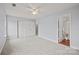 Bedroom with carpet, closet, ceiling fan, and entryway to bathroom at 233 E Waterlynn Rd # B, Mooresville, NC 28117