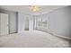 Bright bedroom with neutral carpet, ceiling fan, and ample natural light at 233 E Waterlynn Rd # B, Mooresville, NC 28117
