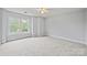 Spacious carpeted bedroom with a ceiling fan and bright, natural light at 233 E Waterlynn Rd # B, Mooresville, NC 28117