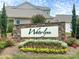 Waterlynn community entrance sign surrounded by flowers and greenery under a cloudy blue sky at 233 E Waterlynn Rd # B, Mooresville, NC 28117