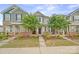 Charming townhome with stone accents, covered porch, manicured lawn, and inviting curb appeal in a friendly neighborhood at 233 E Waterlynn Rd # B, Mooresville, NC 28117