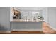 Well-lit kitchen showcasing granite countertops, a stainless steel sink, and a convenient breakfast bar seating area at 233 E Waterlynn Rd # B, Mooresville, NC 28117