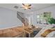 Bright living room with hardwood floors, a comfortable sofa, and view of the staircase at 233 E Waterlynn Rd # B, Mooresville, NC 28117