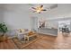 Open-concept living area with wood floors, a neutral sofa, access to the kitchen, and plenty of natural light at 233 E Waterlynn Rd # B, Mooresville, NC 28117