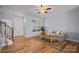 Inviting living room with wood floors, a cozy sofa, a decorative rug, and access to the staircase and front door at 233 E Waterlynn Rd # B, Mooresville, NC 28117