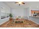 Cozy living room with wood floors, large windows, a comfortable sofa, and access to the kitchen at 233 E Waterlynn Rd # B, Mooresville, NC 28117