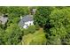 Aerial view of a white brick home with landscaped grounds, mature trees, and a lush green lawn at 2556 Howerton Ct, Charlotte, NC 28270