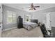 Clean bedroom with neutral walls, a ceiling fan, a chest of drawers, and a large window with plantation shutters at 2556 Howerton Ct, Charlotte, NC 28270
