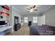 Bedroom featuring built in shelving, ceiling fan, carpet, and two windows allowing natural light at 2556 Howerton Ct, Charlotte, NC 28270