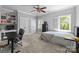 Bright bedroom with built-in shelving, a ceiling fan, neutral walls, and a large window with plantation shutters at 2556 Howerton Ct, Charlotte, NC 28270