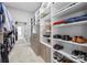Spacious walk-in closet with built in shelves, drawers, and a mirror, offering ample storage for shoes and clothing at 2556 Howerton Ct, Charlotte, NC 28270