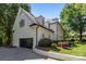 Stately white brick home with a black garage door, dormer windows, and well-maintained landscaping at 2556 Howerton Ct, Charlotte, NC 28270