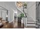 Stunning foyer with a grand staircase, hardwood floors, and stylish lighting fixtures at 2556 Howerton Ct, Charlotte, NC 28270
