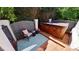 Secluded brick patio with a wooden hot tub, chair, blue rug, and privacy fence surrounded by lush greenery at 2556 Howerton Ct, Charlotte, NC 28270