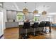 Kitchen island with granite countertops, pendant lighting, hardwood floors and seating for four at 2556 Howerton Ct, Charlotte, NC 28270