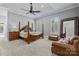 This main bedroom features a tray ceiling, a ceiling fan, and plenty of natural light from windows with white shutters at 2556 Howerton Ct, Charlotte, NC 28270