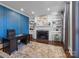 Well-appointed office featuring built-in bookshelves, a fireplace, and stylish decor at 2556 Howerton Ct, Charlotte, NC 28270