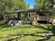 View of wooded siding home with basement garage at 3063 Liledoun Rd, Taylorsville, NC 28681