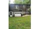 Side view of home showing basement garage entrance and wooded siding at 3063 Liledoun Rd, Taylorsville, NC 28681