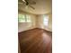Bedroom featuring hardwood flooring, ceiling fan, and natural light from two windows at 3063 Liledoun Rd, Taylorsville, NC 28681