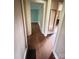Hallway view showcasing hardwood floors, trim, and multiple doorways to other rooms at 3063 Liledoun Rd, Taylorsville, NC 28681