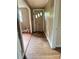 Hallway with hardwood floors leads to the front door, offering a view of the interior at 3063 Liledoun Rd, Taylorsville, NC 28681