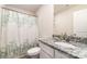Well-lit bathroom featuring a granite vanity, patterned shower curtain, and modern fixtures at 3138 Maple Ridge Dr, Gastonia, NC 28052