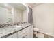 Well-lit bathroom featuring granite countertops, white cabinets, a shower, and a large mirror creating a bright, clean space at 3138 Maple Ridge Dr, Gastonia, NC 28052