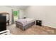 Bedroom with neutral carpet, a window, and a twin bed is bathed in soft, natural light, enhancing the cozy atmosphere at 3138 Maple Ridge Dr, Gastonia, NC 28052