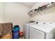 Functional laundry room with side-by-side washer and dryer, complemented by storage shelves and practical laundry organization at 3138 Maple Ridge Dr, Gastonia, NC 28052