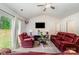 Inviting living area with red leather furniture, a flat-screen TV, and sliding glass doors for bright, open living at 3138 Maple Ridge Dr, Gastonia, NC 28052