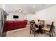 Open floor plan with red leather seating, a glass dining table, and neutral walls provide a warm, inviting living space at 3138 Maple Ridge Dr, Gastonia, NC 28052