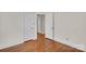 Hardwood floors and white doors highlight the interior of this bedroom at 3733 Manchester Dr, Charlotte, NC 28217