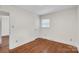 Bright bedroom with hardwood floors, a window and white trim, creating a cozy living space at 3733 Manchester Dr, Charlotte, NC 28217