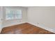 Bedroom with hardwood floors and bright windows offers comfortable and stylish living at 3733 Manchester Dr, Charlotte, NC 28217