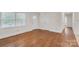 Bedroom with hardwood flooring, and natural light showcases a serene and comfortable living space at 3733 Manchester Dr, Charlotte, NC 28217