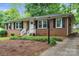 Charming brick home with black shutters, white trim, and well-maintained landscaping offers curb appeal at 3733 Manchester Dr, Charlotte, NC 28217