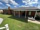 Exterior backyard view featuring covered patio and lush green lawn at 396 Pitts School Nw Rd, Concord, NC 28027