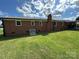 Well-maintained backyard with lush green lawn and brick exterior at 396 Pitts School Nw Rd, Concord, NC 28027