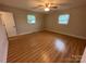 Cozy bedroom featuring neutral colors, wood floors and two windows at 396 Pitts School Nw Rd, Concord, NC 28027